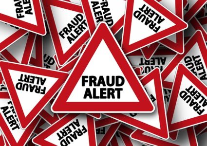 Fraud Alert triangular signs in pile