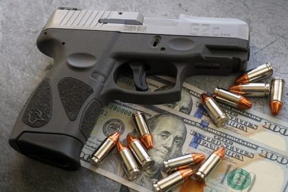 Pistol bullets and hundred dollar bills