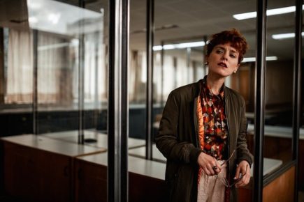 Lady in office standing up