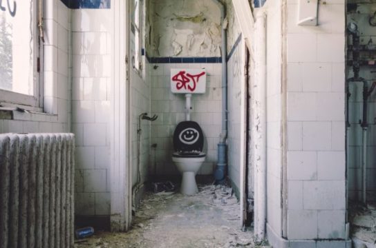 Gross bathroom with graffitti