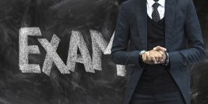 Male teacher in front of blackboard