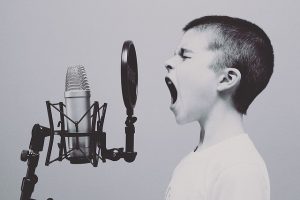 Young male in front of microphone