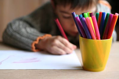 Child drawing a picture whose parent may file a school discrimination complaint after being harassed for his race, ethnicity, gender, sexual orientation and disability.