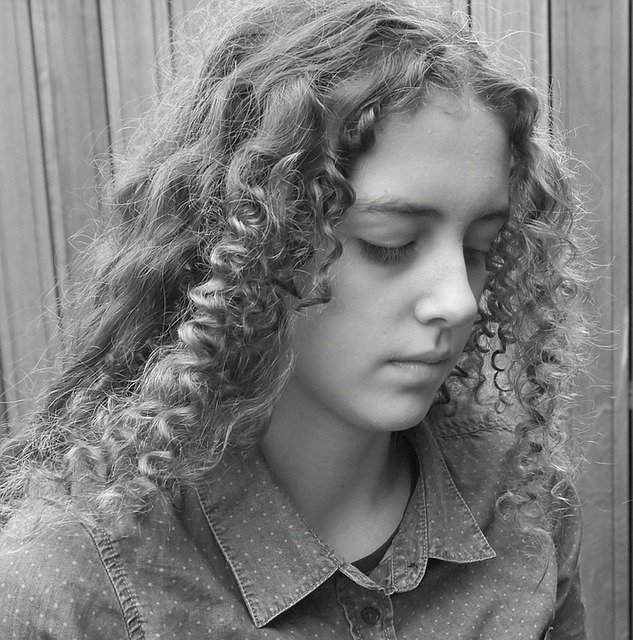 Girl looking down after falsely accused and punished