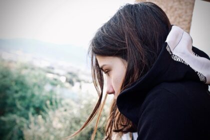 Girl looking to the side and down, sad