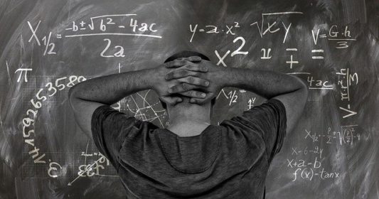 Chalkboard with black student with hands on head