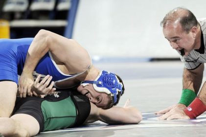 referee watching a wrestling match