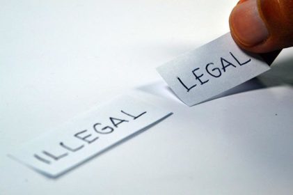 Papers with illegal and legal on them and decision