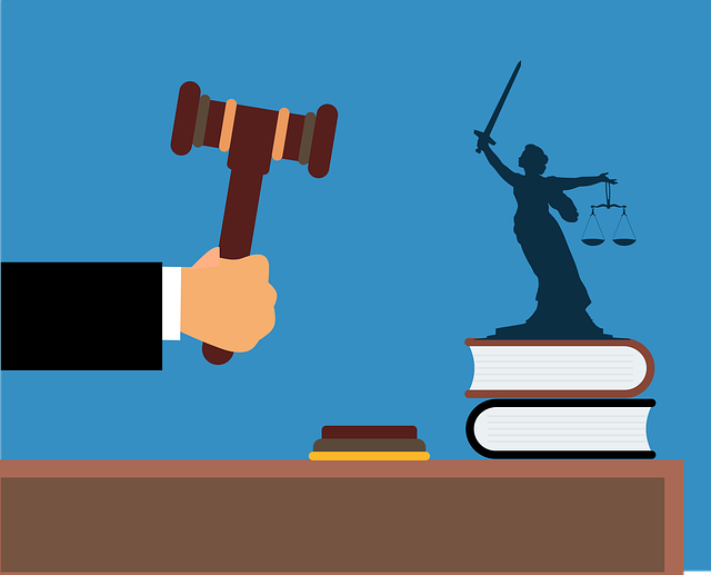 Graphic of gavel with small symbol of lady justice holding sword