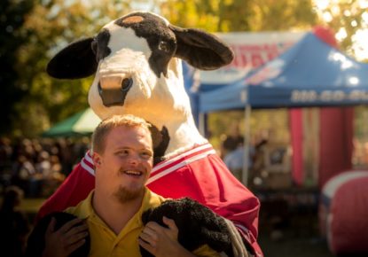 Male teen with downs syndrome holding stuffed cow