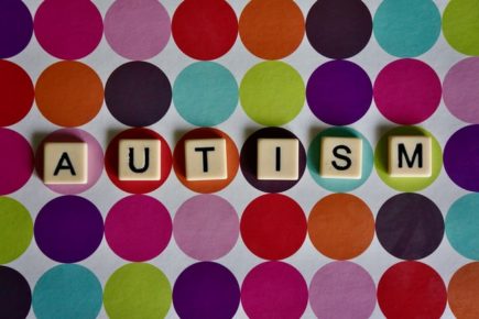 Autism sign with large colorful dot background