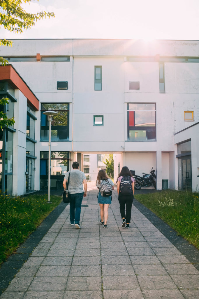 Three students walking away