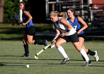 Girls playing field hockey