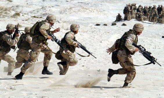 Military members running away with rifles in snow
