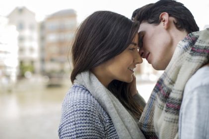 Two teens close to each other about to kiss