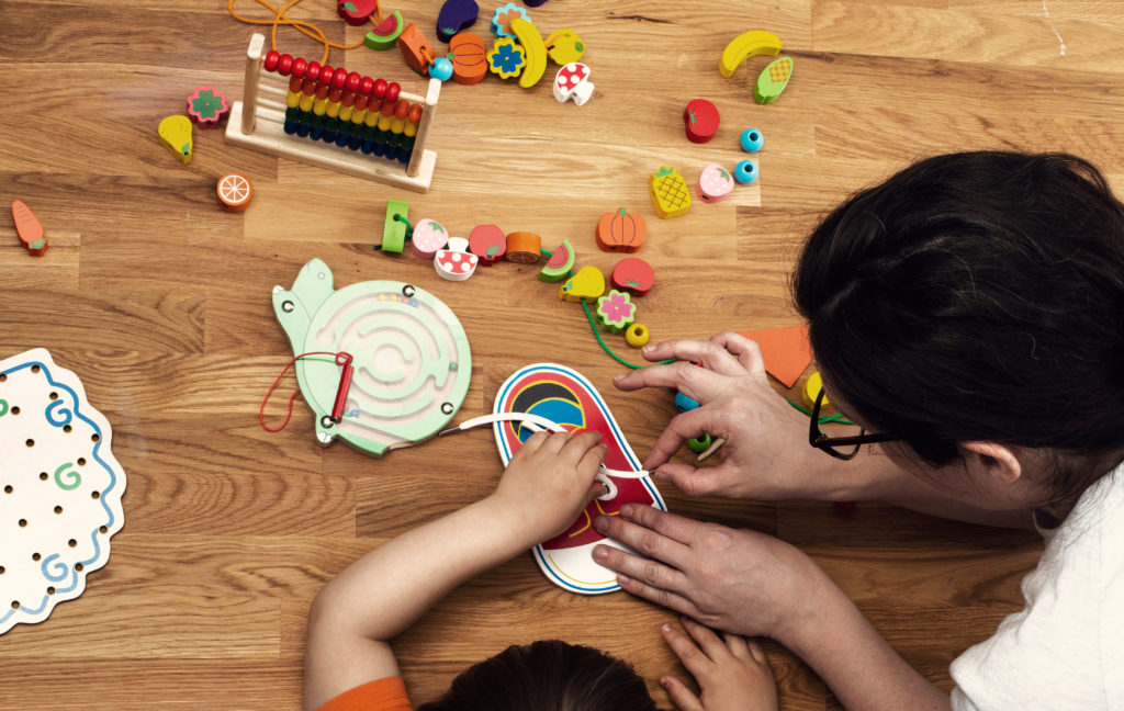 early-childhood-educator-with-toys-and-child