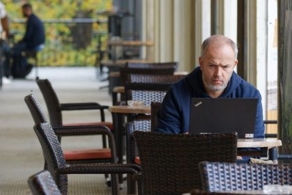 Parent at computer, sitting at table