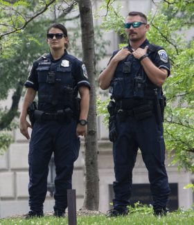Two police male and female standing outside