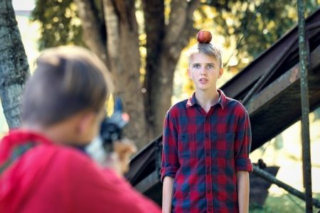 Boy with apple on top of head