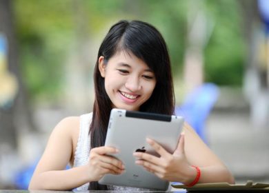 Female teen with tablet smiling