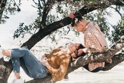 Students gazing at each other in a tree, male and female