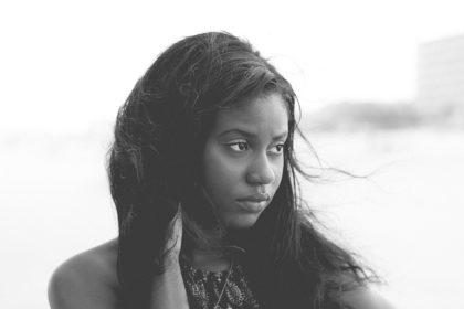 African American teen female looking sideways in wind