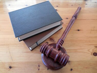 2 law books and gavel on wooden table
