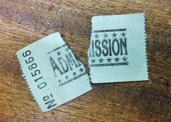 ripped admission ticket on wooden table