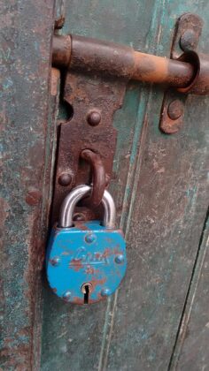A padlock on an old door
