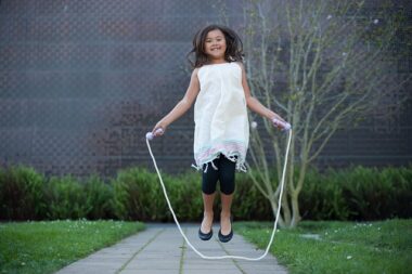 Girl jumpropes outside