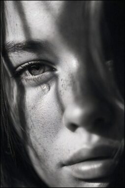 Girl, crying, staring into camera, black and white photo