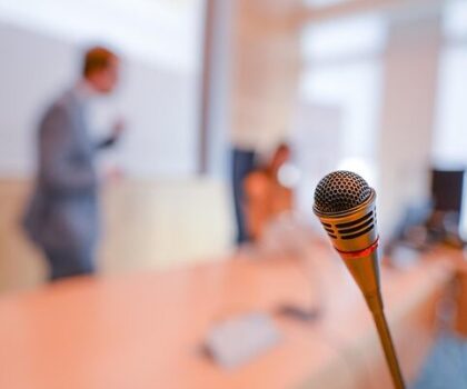 microphone near man talking in meeting